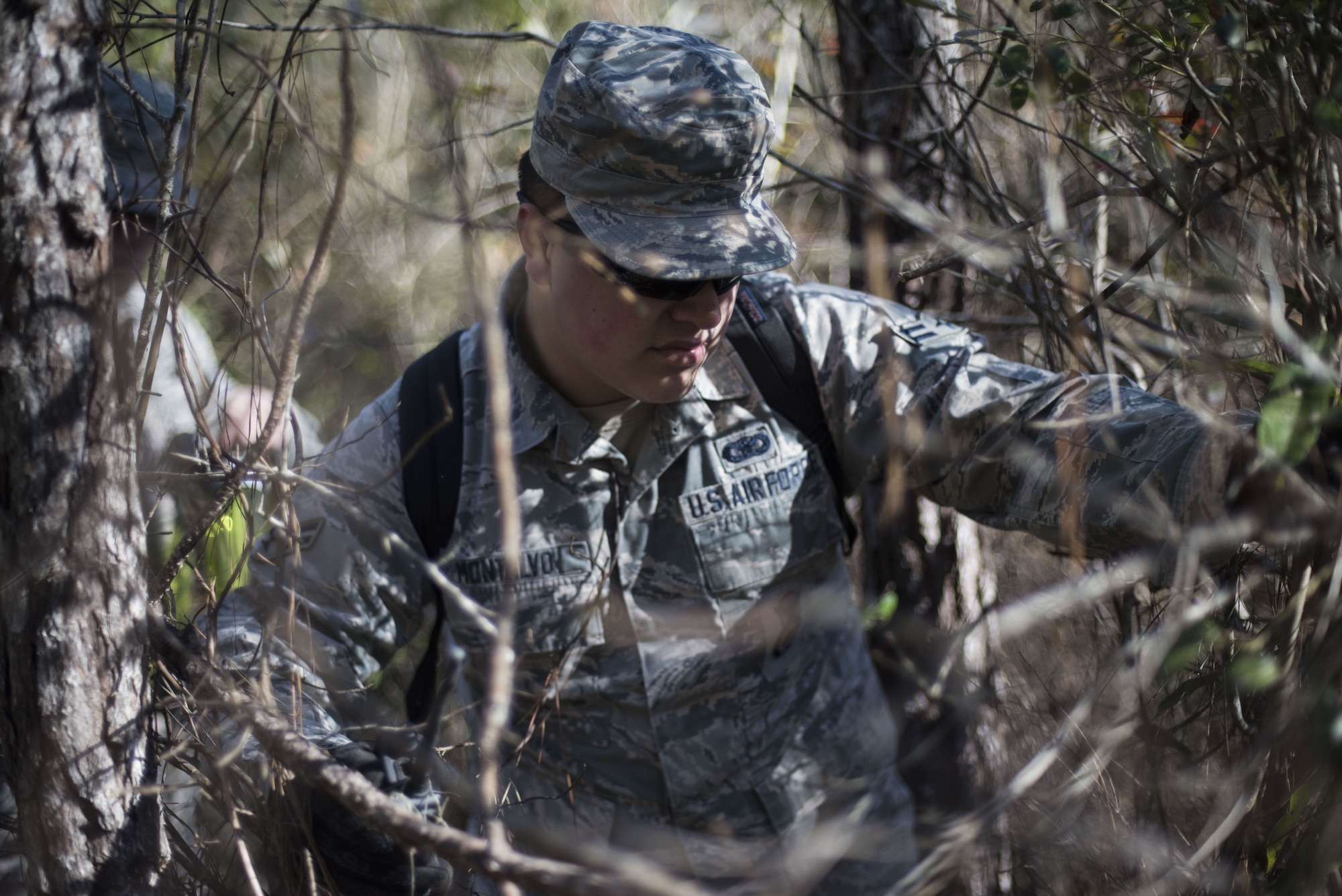 Airman 1st Class Anthony Montalvo, 824th Base Defense Squadron fireteam member, traverses through the woods while scanning for signs of an improvised explosive device (IED) during training, Jan. 24, 2018, at Moody Air Force Base, Ga. The 820th Base Defense Group defenders trained on how to detect IEDs and counter measures to take when one is found. IEDs have become one of the most common forms of attack in the Middle East since 2003. (U.S. Air Force photos by Staff Sgt. Eric Summers Jr.)