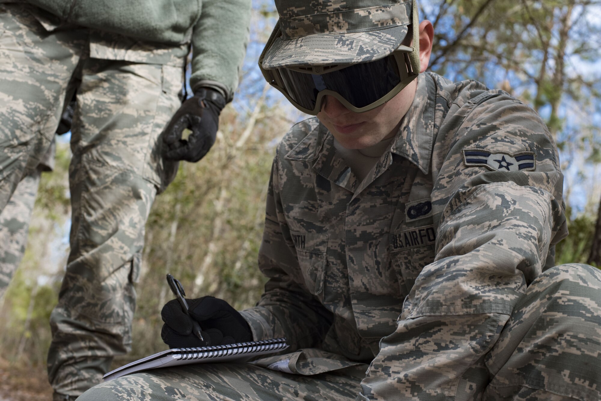 Airman 1st Class Kevin Smith, 824th Defense Squadron fireteam member, records a nine-line report to pass along information of a simulated improvised explosive device during training Jan. 24, 2018, at Moody Air Force Base, Ga. The 820th Base Defense Group defenders trained on how to detect IEDs and counter measures to take when one is found. IEDs have become one of the most common forms of attack in the Middle East since 2003. (U.S. Air Force photos by Staff Sgt. Eric Summers Jr.)
