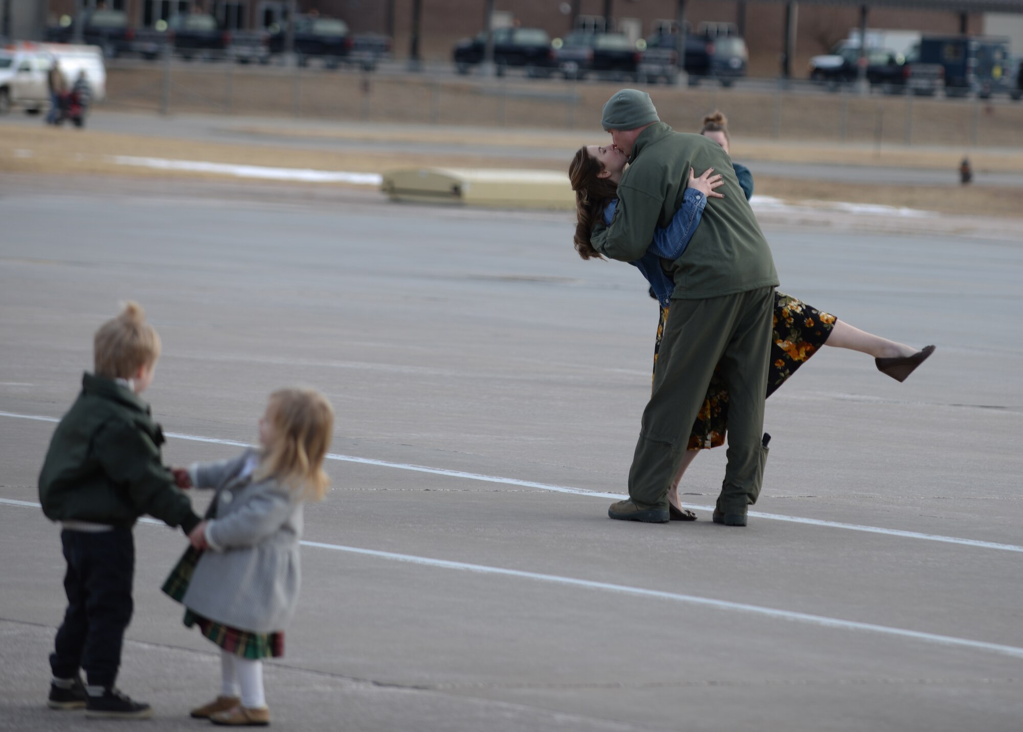 Maj. Jeremey, a pilot assigned to the 37th Bomb Squadron, kisses his wife on the flight line at Ellsworth Air Force Base, S.D., after returning from a six-month deployment to Andersen AFB, Guam, Jan. 25, 2018. B-1 bomber aircrews conducted sorties close to South Korea’s northern border as part of the U.S. Pacific Command’s Continuous Bomber Presence mission. (U.S. Air Force photo by Airman 1st Class Thomas Karol)