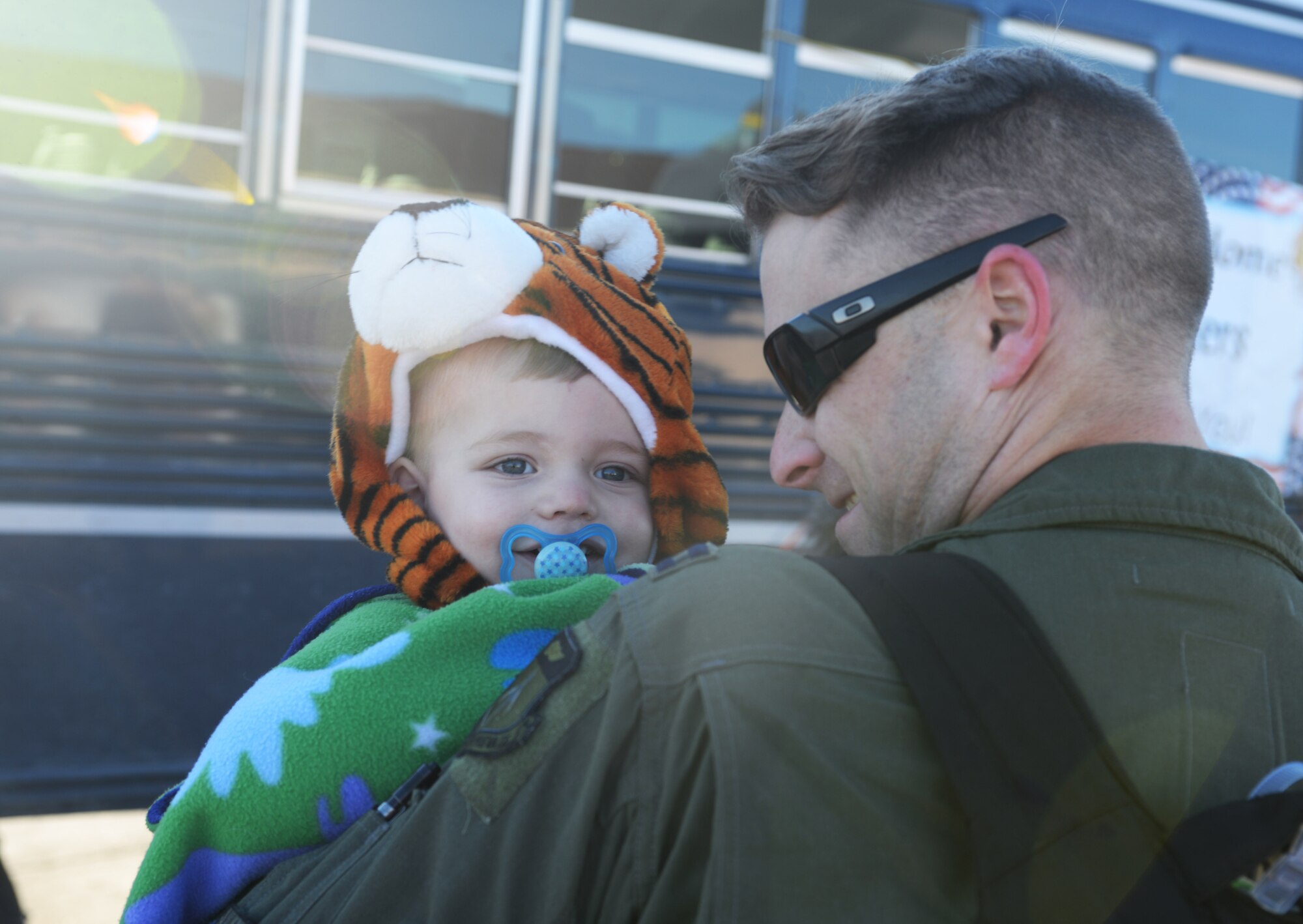 Capt. Chad, a weapons system officer assigned to the 37th Bomb Squadron, holds his son, Grant, at Ellsworth Air Force Base, S.D., Jan. 25, 2018, after returning from a six-month deployment. B-1 bomber aircrews conducted sorties close to South Korea’s northern border as part of the U.S. Pacific Command’s Continuous Bomber Presence mission. (U.S. Air Force photo by Airman 1st Class Thomas Karol)