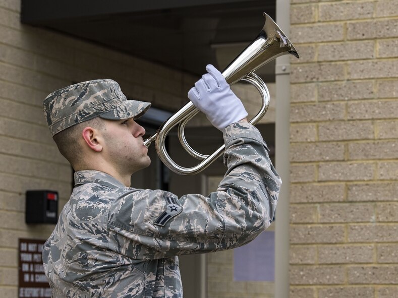 Airman 1st Class Nicholas Miller, 736th Aircraft Maintenance Squadron C-17 aerospace maintenance journeyman and Base Honor Guard member, plays Taps as retired Military Working Dog Rico is carried by his owner, retired Tech. Sgt. Jason Spangenberg, to the Veterinary Treatment Facility Jan. 24, 2018, on Dover Air Force Base, Del. MWD Rico retired from the U.S. Air Force Jan. 15, 2016 after serving more than seven years on active duty. (U.S. Air Force photo by Roland Balik)