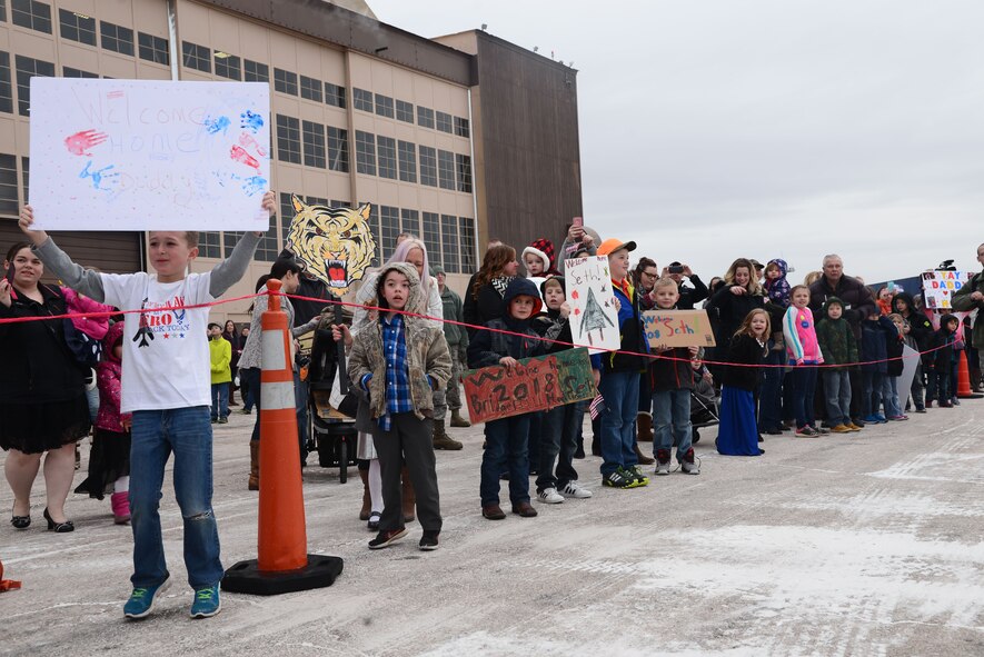 Family members wait to see Airmen returning from a six-month deployment to Andersen Air Force Base, Guam, at the Pride Hangar at Ellsworth AFB, S.D., Jan. 29, 2018. B-1 bombers from the 37th Bomb Squadron and Airmen from the 37th Aircraft Maintenance Unit were deployed to Andersen AFB, to take part in the Continuous Bomber Presence mission. (U.S. Air Force photo by Airman 1st Class Donald Knechtel)