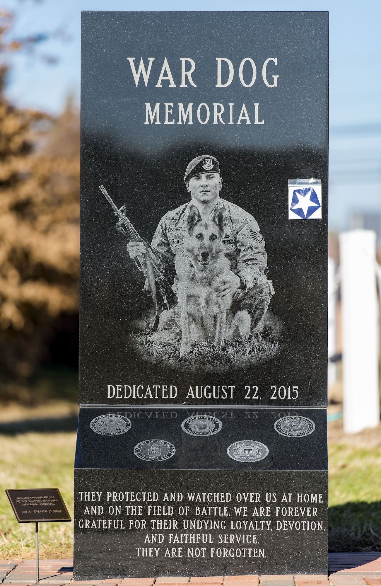 The War Dog Memorial features a picture engraved in granite of then-Staff. Sgt. Jason Spangenberg, 436th Security Forces Squadron, and Military Working Dog Rico, and sits in the Kent County Veterans Memorial Park, Dover, Del., Jan. 25, 2018. The War Dog Memorial was the first of its kind in Delaware. (U.S. Air Force photo by Roland Balik)