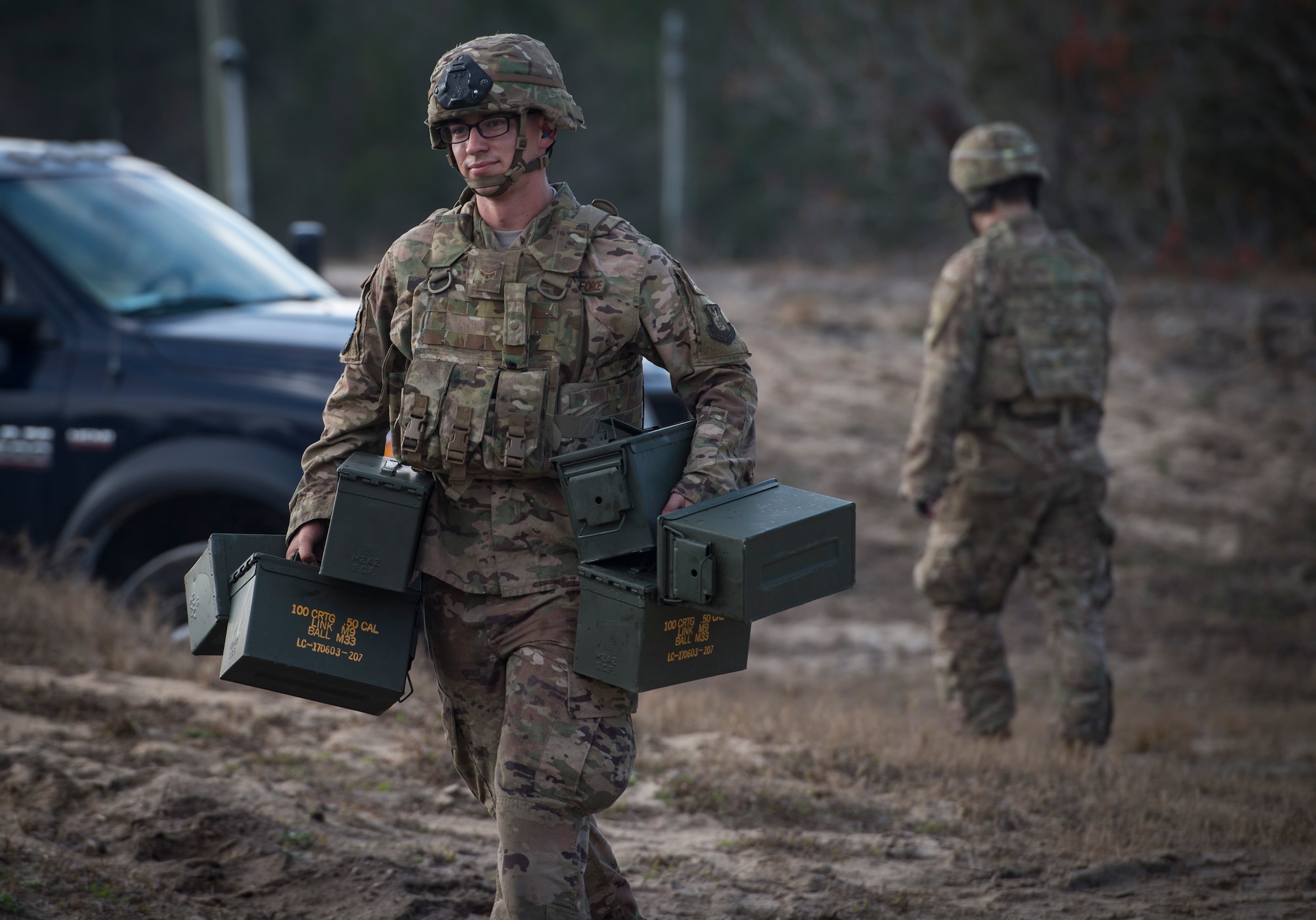 An Airman from the 824th Base Defense Squadron carries empty ammunition boxes during Weapons Week, Jan. 23, 2018, at Camp Blanding Joint Training Center, Fla. During Weapons Week, Airmen qualify on heavy weapons to include the M2 machine gun, Mark 19 40mm grenade machine gun, M240B machine gun, M249 light machine gun, M136E1 AT4-CS confined space light anti-armor weapon, and M18 Claymore mine. (U.S. Air Force photo by Senior Airman Janiqua P. Robinson)