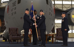 Col. Mark Harris, left, 437th Maintenance Group commander, passes the guideon to Maj. David Rhodes, right, 437th Maintenance Squadron incoming commander, during a change of command ceremony at Joint Base Charleston, S.C., Jan. 26, 2018. Rhodes assumed command of the squadron following the outgoing commander Lt. Col. Michael Coppola.