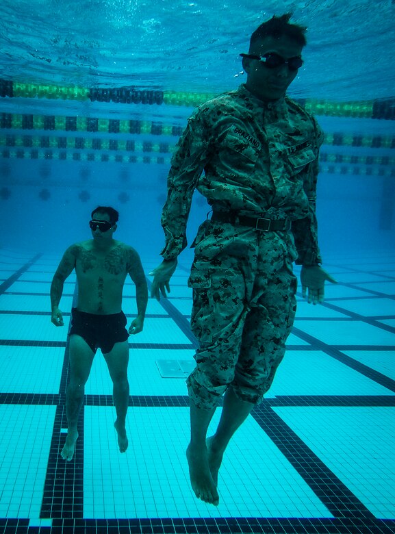 U.S. Marine Corps Pfc. Michael Garziano, an infantryman with Detachment 4th Force Reconnaissance Company, resurfaces from the bottom of the pool as part of a water treading exercise during a training event, Marine Corps Base Hawaii, Jan. 22, 2018. The event consisted of various exercises, including a 25 meter underwater swim, static breath holds, a 1km swim, and gear retrievals. The unit’s training program aims to prepare students for the stresses of the BRC by offering a broad, realistic curriculum, challenging them both mentally and physically. (U.S. Marine Corps photo by Lance Cpl. Luke Kuennen)