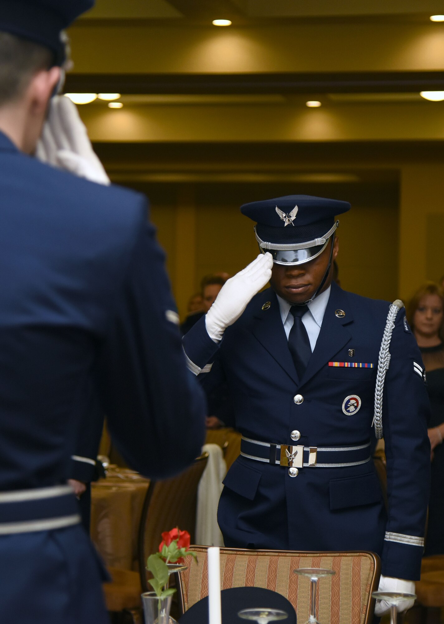 A Keesler Air Force Base Honor Guard member renders a salute during a POW/MIA tribute during the 2017 Keesler Annual Awards Ceremony at the Bay Breeze Event Center Jan. 25, 2018, on Keesler Air Force Base, Mississippi. During the ceremony base leadership recognized outstanding Airmen and civilians from across the installation for their accomplishments throughout 2017. (U.S. Air Force photo by Kemberly Groue)