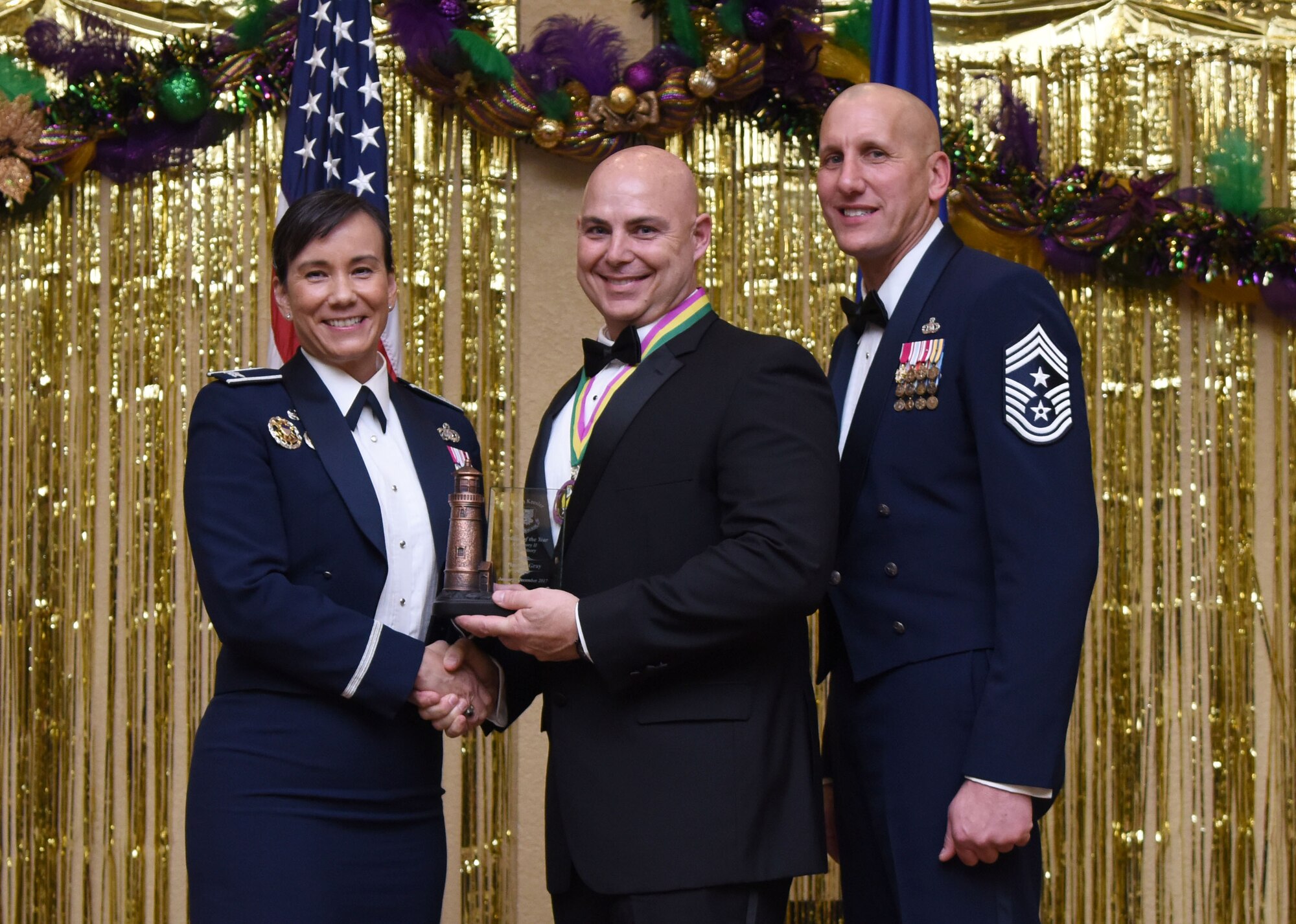 Col. Debra Lovette, 81st Training Wing commander, and Chief Master Sgt. Kenneth Carter, 81st TRW command chief, present Timothy Gray, 81st Logistics Readiness Squadron vehicle management flight chief, with the Civilian Supervisory Category II Annual Award during the 2017 Keesler Annual Awards Ceremony at the Bay Breeze Event Center Jan. 25, 2018, on Keesler Air Force Base, Mississippi. During the ceremony base leadership recognized outstanding Airmen and civilians from across the installation for their accomplishments throughout 2017. (U.S. Air Force photo by Kemberly Groue)