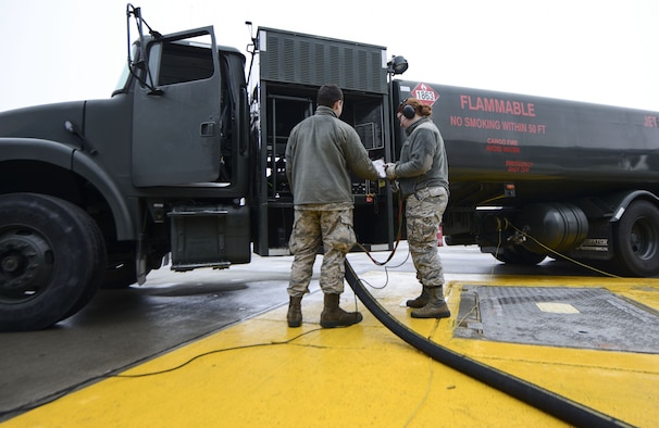 Airman 1st Class Nathan Hopkins trains Airman Britney Hogue how to defuel a KC-135 Stratotanker using an R-12 fuel truck. POL Airmen are responsible for providing optimal refueling support on and off the flight line. Both Hopkins and Hogue are 92nd Logistics Readiness Squadron fuels distribution operators. (U.S. Air Force photo/Senior Airman Janelle Patiño)