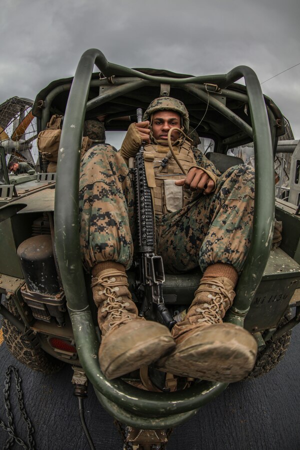 Private First Class Joshua Webb, with Alpha Battery,11th Marines, sits in the back seat of a M1163 Prime Mover as they load onto a Landing Craft Air Cushion as part of Iron Fist 2018, Jan. 19. Iron Fist is a five-week-long exercise focusing on advanced marksmanship, amphibious reconnaissance, fire and maneuver assaults, staff planning, logistical support, medical knowledge sharing, fire support operations, including mortars, artillery and close air support, and amphibious landing operations. (U.S. Marine Corps photo by Gunnery Sgt. Robert B. Brown Jr.)