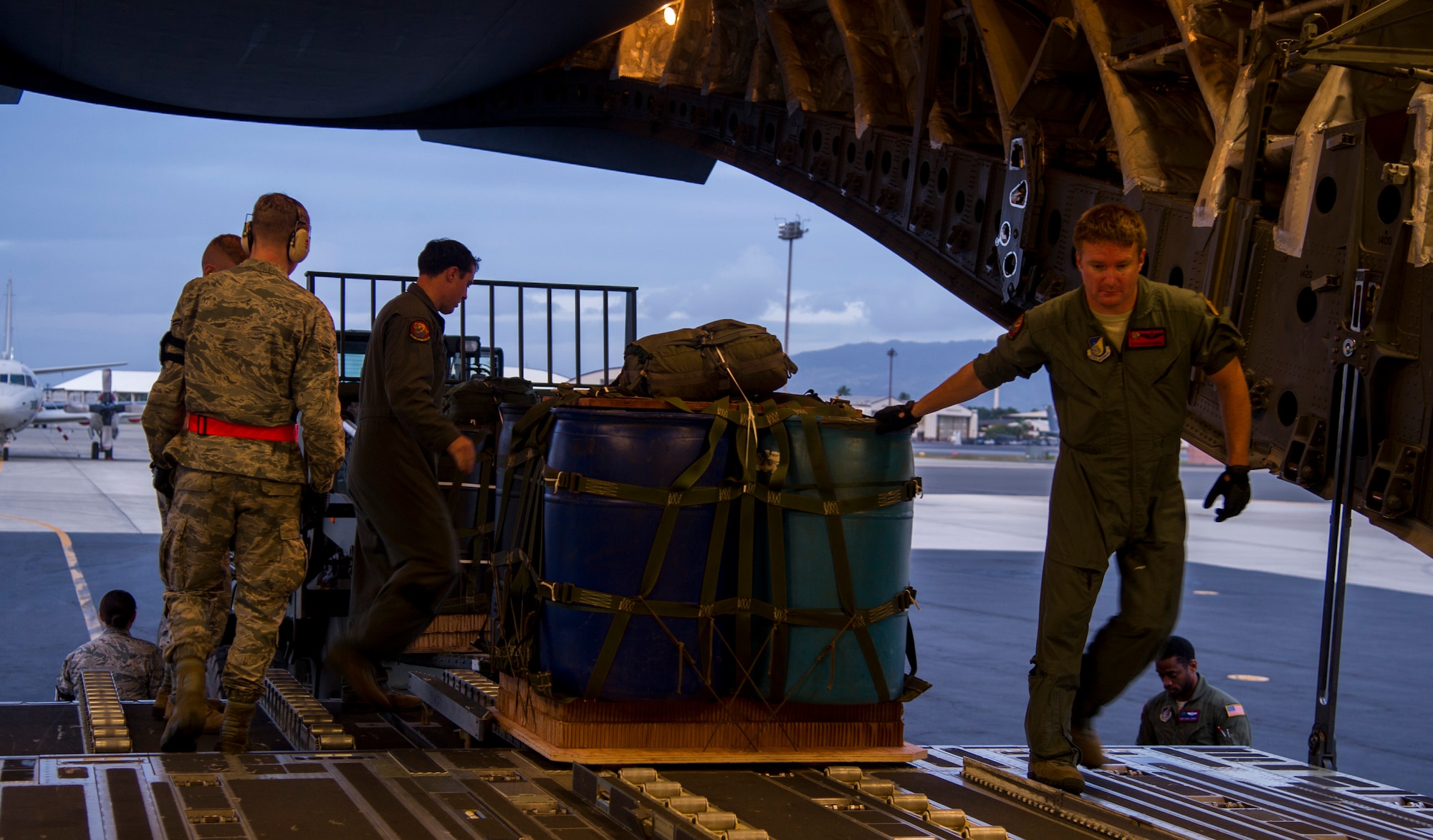 Loadmasters assigned to the 535th Airlift Squadron load cargo pallets onto a C-17 Globemaster III for an airdrop mission at Joint Base Pearl Harbor-Hickam, Hawaii, Jan. 25, 2018. Airdrop missions are part of the routine training for aircrew and logistics personnel. (U.S. Air Force photo by Tech. Sgt. Heather Redman)
