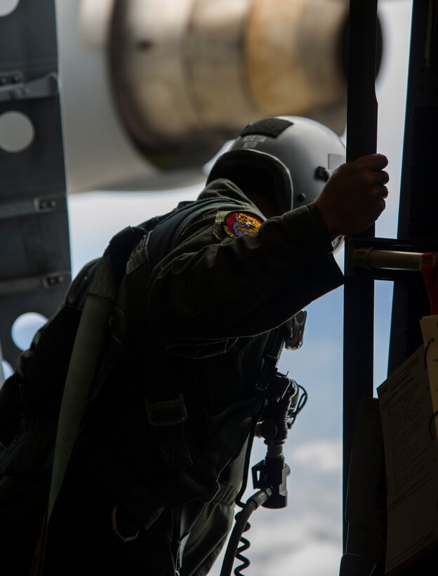 Tech. Sgt. Douglas Tadevich, 535th Airlift Squadron loadmaster, observes the drop zone from a C-17 Globemaster III during an airdrop mission over Big Island, Hawaii, Jan. 25, 2018. Airdrop missions are part of the routine training for aircrew and logistics personnel. (U.S. Air Force photo by Tech. Sgt. Heather Redman)