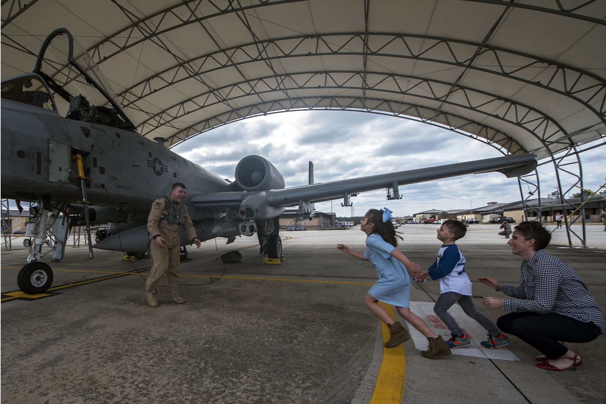 Lt. Col. Craig Morash, 74th Fighter Squadron commander, prepares to hug his children after returning from a deployment, Jan. 26, 2018, at Moody Air Force Base, Ga. The well-being of children is paramount to Airmen readiness for deployment. While most children are resilient and can handle the changes that come when a parent deploys, some children face challenges. (U.S. Air Force photo by Airman Eugene Oliver)