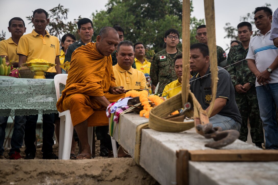 A Buddhist priest rubs powder on the main pillar during a pillar-raising ceremony in support of Exercise Cobra Gold 2018 at Ban Pan Mo School in Chanthaburi Province, Kingdom of Thailand, Jan. 24, 2018. The ceremony marked the official start of engineering civic assistance projects for the exercise. Thailand, the U.S. and their regional partners are committed to working together in areas of common interest for the betterment of regional security. Our long-standing alliance and partnership continues to grow and strengthen. (U.S. Marine Corps photo by Sgt. Matthew J. Bragg)