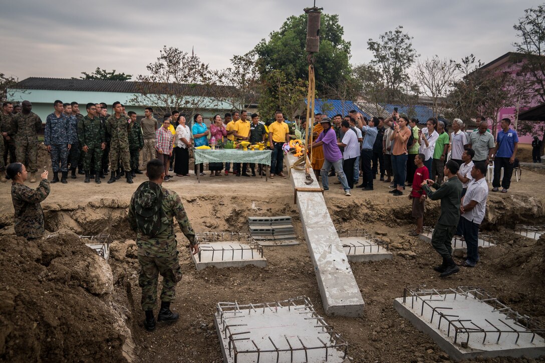 The main pillar of a multifunctional building is raised during a pillar-raising ceremony in support of Exercise Cobra Gold 2018 at Ban Pan Mo School in Chanthaburi Province, Kingdom of Thailand, Jan. 24, 2018. The ceremony marked the official start of engineering civic assistance projects for the exercise. Cobra Gold is in its 37th iteration, and humanitarian civic assistance projects conducted during the exercise support the needs and humanitarian interests of the Thai people. (U.S. Marine Corps photo by Sgt. Matthew J. Bragg)