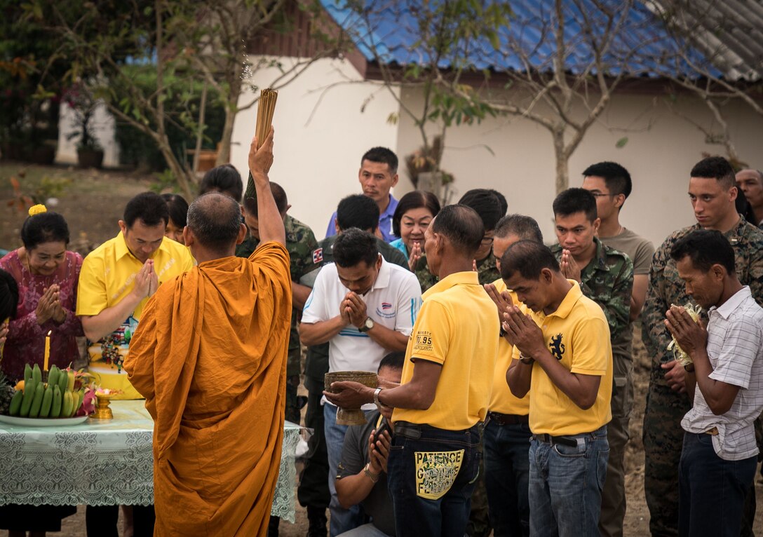 A Buddhist monk blesses villagers and multinational troops to conclude a pillar-raising ceremony in support of Exercise Cobra Gold 2018 at Ban Pan Mo School in Chanthaburi, Kingdom of Thailand, Jan. 24, 2018. According to tradition, the main pillar of a building is blessed in order to please the spirits of the area so that no harm comes to the building in the future. The ceremony marked the official start of engineering civic assistance projects for the exercise. (U.S. Marine Corps photo by Sgt. Matthew J. Bragg)