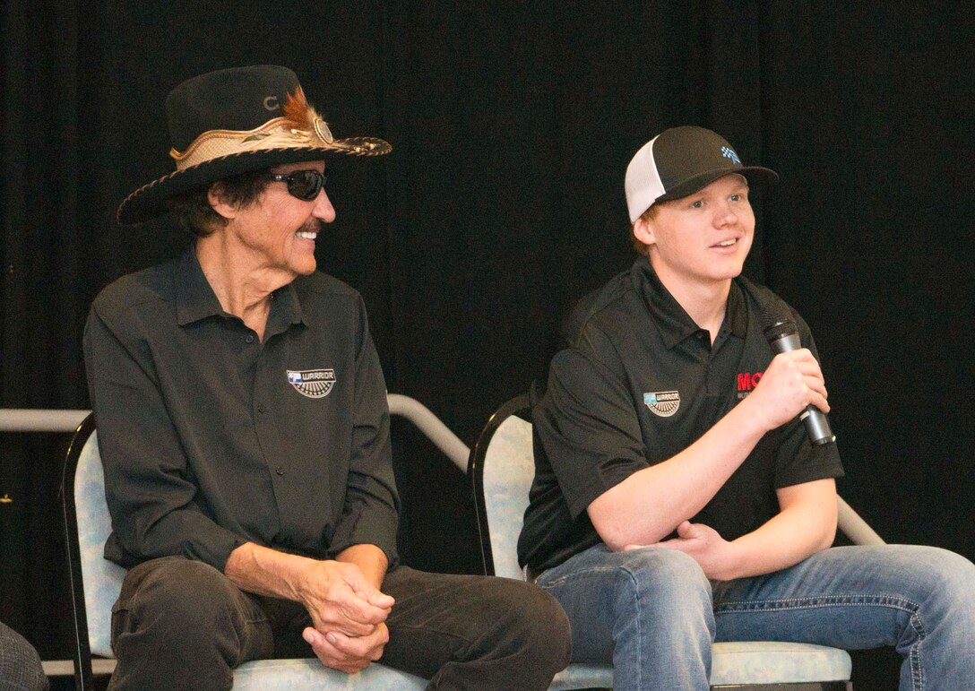 Richard Petty, left, and his grandson, Thad Moffitt, both Nascar drivers, answer questions for Team Ramstein at the Kaiserslautern Military Community Center on Ramstein Air Base, Germany, Jan. 27, 2018. Petty and Moffitt signed memorabilia, posed for pictures with service members and their families, and participated in a question and answer session. (U.S. Air Force photo by Senior Airman Elizabeth Baker)