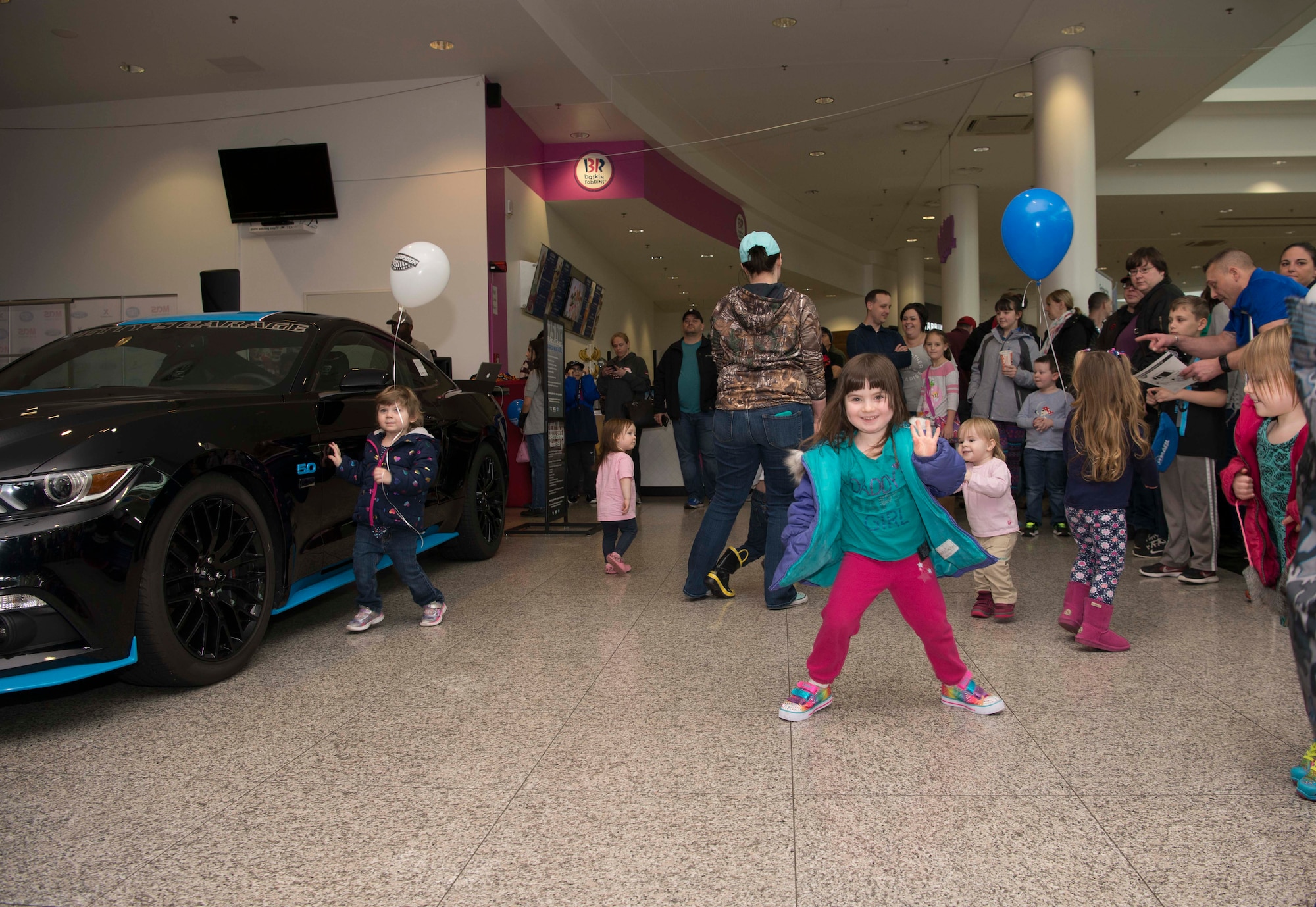 Children dance while waiting to see Richard Petty, Nascar legend, at a Kaiserslautern Military Community Center event on Ramstein Air Base, Germany, Jan. 27, 2018. Petty spoke with members of Team Ramstein, signed autographs, and participated in a question and answer session. (U.S. Air Force photo by Senior Airman Elizabeth Baker)