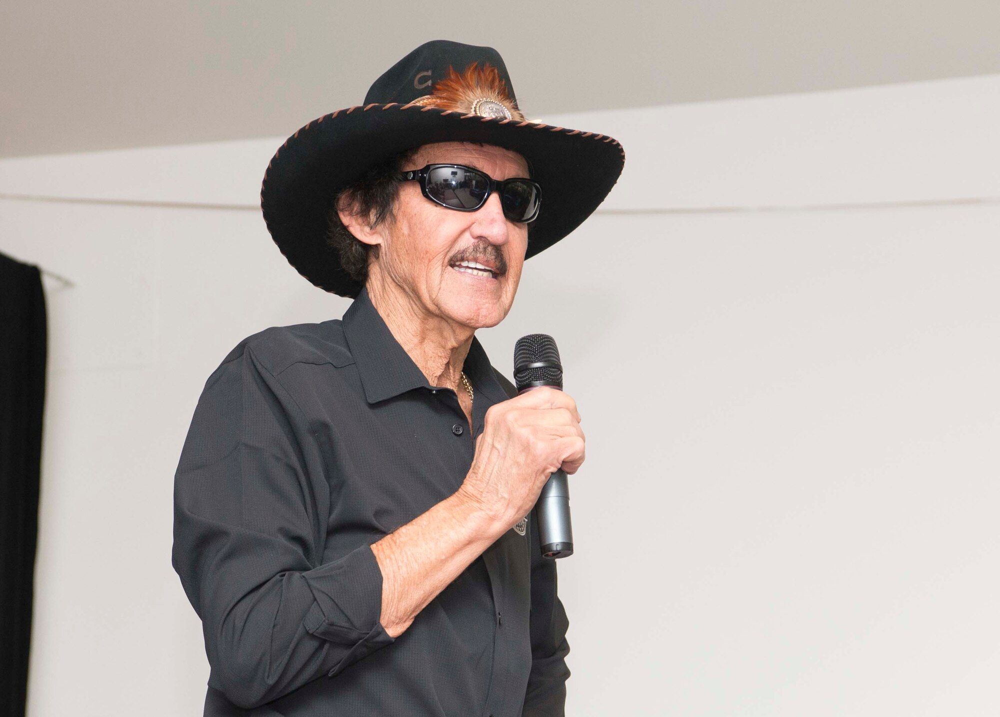 Richard Petty, Nascar legend, speaks to members of Team Ramstein at the Kaiserslautern Military Community Center on Ramstein Air Base, Germany, Jan. 27, 2018. Petty spoke about his career with young men and women in the process of joining the military, met various Team Ramstein leadership, and answered questions at an open event for the Kaiserslautern Military Community. (U.S. Air Force photo by Senior Airman Elizabeth Baker)