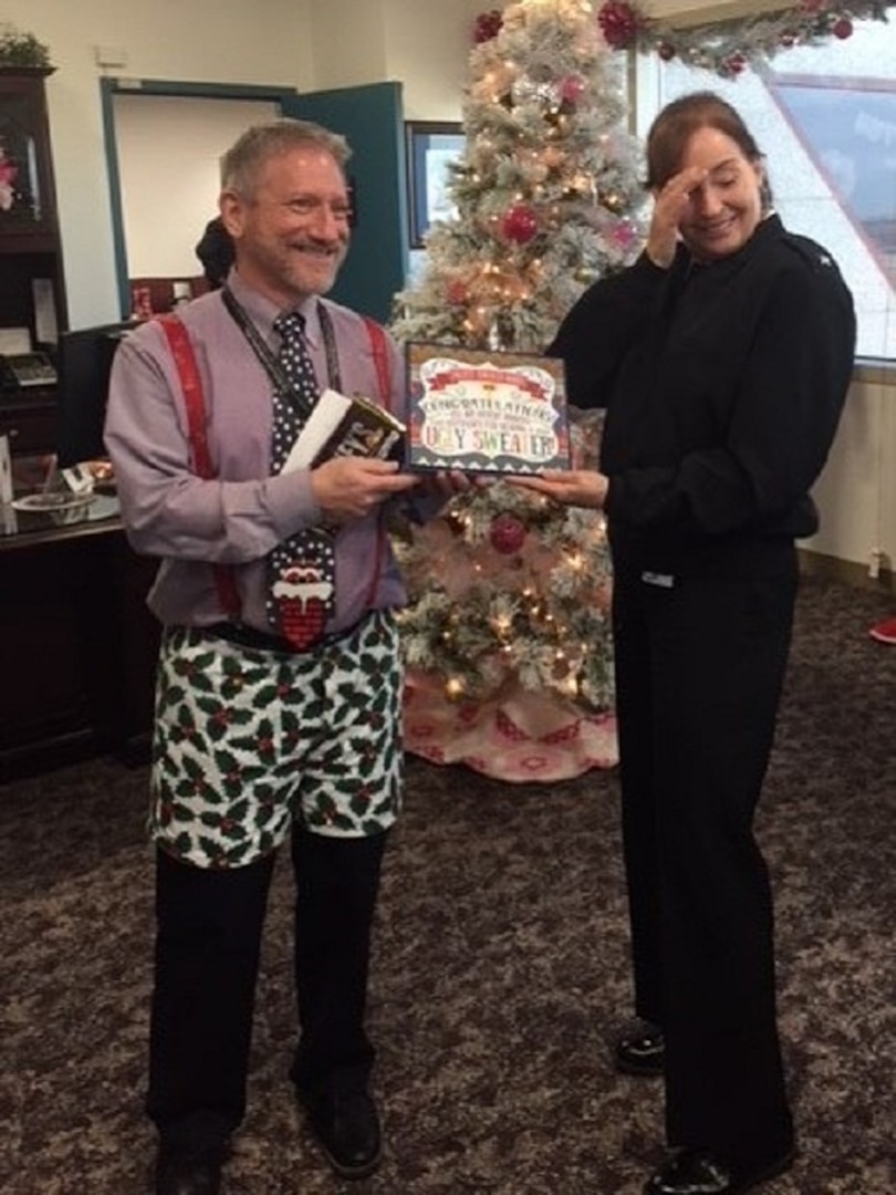 People and Culture winner, Jim, poses with the Commander as he receives his award for the ugliest sweater.