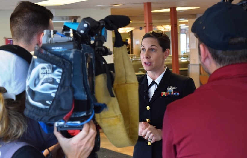 Navy Lt. Cmdr. Erika Schilling, a nurse midwife at Naval Hospital Bremerton, Wash., is interviewed by radio and television reporters in Seattle, Jan. 18, 2018. Shilling was recognized by Washington State Ferries with the Life Ring Award certificate for her life saving efforts on Dec. 2, 2017, when she saved a male passenger's life by administering emergency cardiopulmonary resuscitation for 14 minutes on the Kingston-Edmunds ferry. Navy photo by Douglas H Stutz