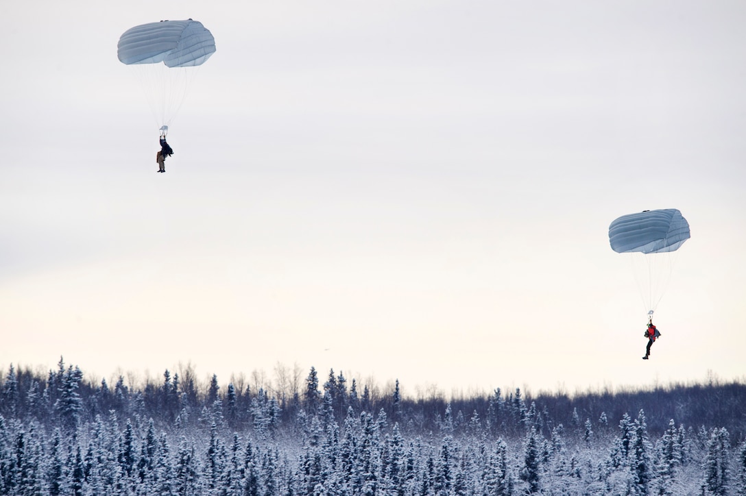 Alaska Air National Guardsmen personnel descend over Malemute drop zone during precision parachute training at Joint Base Elmendorf-Richardson, Alaska.