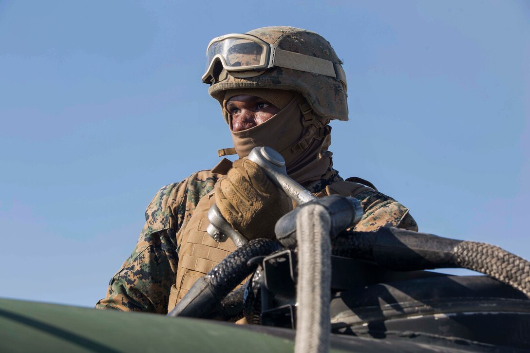 A Marine with Landing Support Company, 2nd Transportation Support Battalion, 2nd Marine Logistics Group braces for the high winds produced by a MV-22 osprey and prepares to attach a 400 gallon M-149 water tank trailer to the aircraft during sling load operations at Camp Lejeune, N.C., Jan. 25, 2018. The Marines conducted sling load operations to improve their proficiency with loading equipment onto aircraft for transportation. (U.S. Marine Corps photo by Sgt. Chris Garcia)