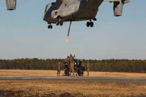 Marines with Landing Support Company, 2nd Transportation Support Battalion, 2nd Marine Logistics Group prepare to attach a 400 gallon M-149 water tank trailer to an MV-22 osprey during sling load operations at Camp Lejeune, N.C., Jan. 25, 2018. The Marines conducted sling load operations to improve their proficiency with loading equipment onto aircraft for transportation. (U.S. Marine Corps photo by Sgt. Chris Garcia)