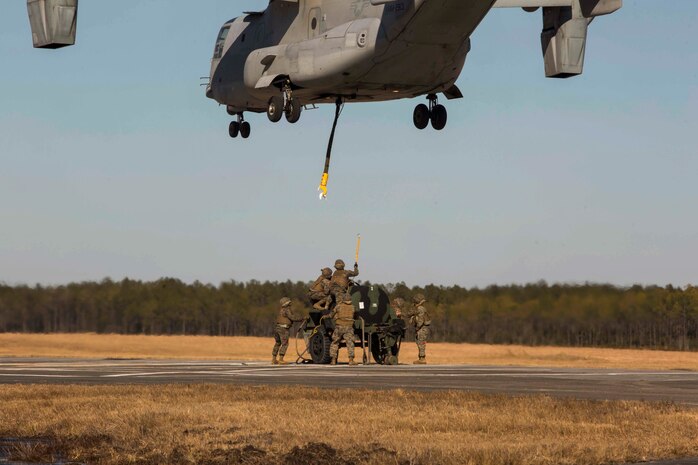 Marines with Landing Support Company, 2nd Transportation Support Battalion, 2nd Marine Logistics Group prepare to attach a 400 gallon M-149 water tank trailer to an MV-22 osprey during sling load operations at Camp Lejeune, N.C., Jan. 25, 2018. The Marines conducted sling load operations to improve their proficiency with loading equipment onto aircraft for transportation. (U.S. Marine Corps photo by Sgt. Chris Garcia)