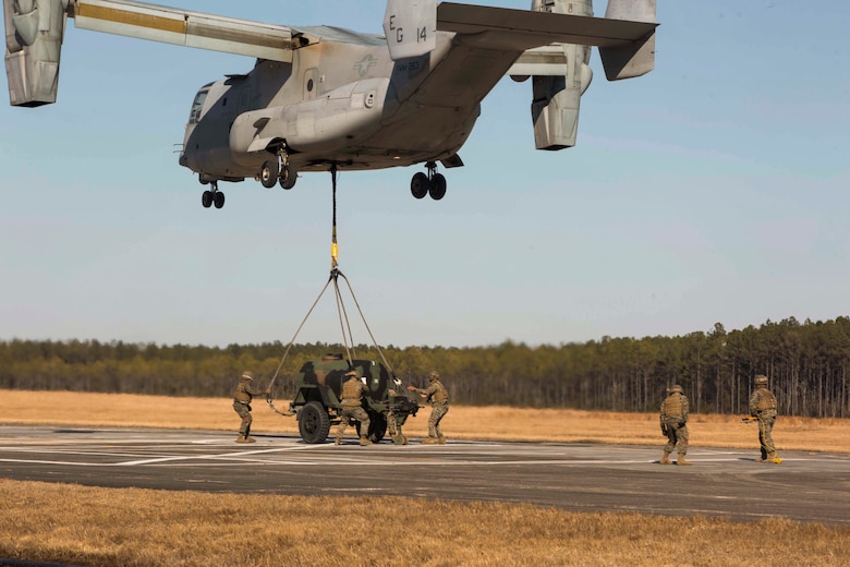 Marines with Landing Support Company, 2nd Transportation Support Battalion, 2nd Marine Logistics Group prepare to attach a 400 gallon M-149 water tank trailer to an MV-22 osprey during sling load operations at Camp Lejeune, N.C., Jan. 25, 2018. The Marines conducted sling load operations to improve their proficiency with loading equipment onto aircraft for transportation. (U.S. Marine Corps photo by Sgt. Chris Garcia)