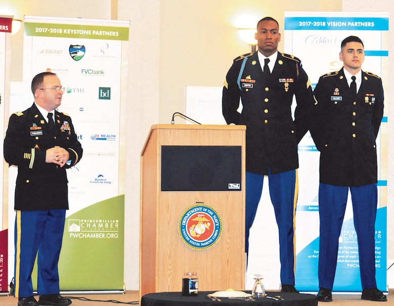 Fort Belvoir Garrison Commander, Lt. Col. Christopher Tomlinson, recognizes soldiers Sgt. Keenan Griffin and Pfc. Jordan Miller for outstanding service during 2017
