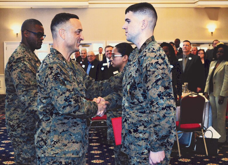 MCINCR-MCBQ Commander Col. Joseph Murray and SGT. Maj. Charles Williams, MCINCR-MCBQ sergeant major, award Lance Cpl. Dylan Williams, Marine of the Year, and Cpl. Brandy Balderas, Noncommissioned Officer of the Year at the Salute to the Armed Forces event at The Clubs at Quantico.