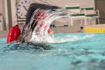 1st Lt. Kyle, 71st Rescue Squadron HC-130J Combat King II combat systems operator, swims towards the ledge of a pool, Jan. 19, 2018, at Moody Air Force Base, Ga. Aircrew members participated in an underwater survival course to prepare themselves for a situation in which their aircraft were to crash in the water. (U.S. Air Force photo by Airman Eugene Oliver)
