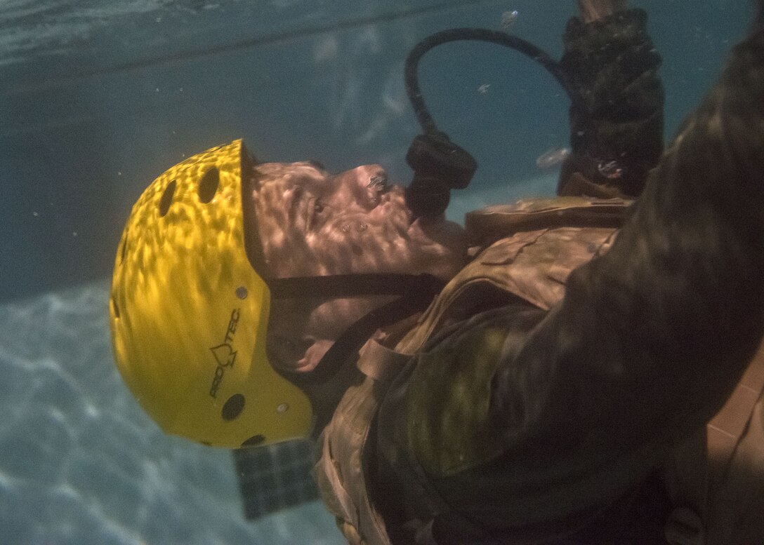 Master Sgt. Robert Alvarado, 41st Rescue Squadron special missions aviator, sinks in a pool, Jan. 25, 2018, at Moody Air Force Base, Ga. Aircrew members participated in an underwater survival course to prepare themselves for a situation in which their aircraft were to crash in the water. (U.S. Air Force photo by Airman Eugene Oliver)