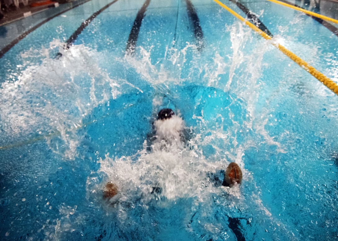 Maj. Zachary Krueger, 75th Fighter Squadron A-10C Thunderbolt II pilot, falls into a pool, Jan. 25, 2018, at Moody Air Force Base, Ga. Aircrew members participated in an underwater survival course to prepare themselves for a situation in which their aircraft were to crash in the water. (U.S. Air Force photo by Airman Eugene Oliver)