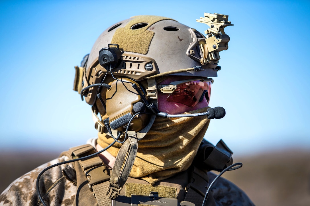 A Marine stands ready to board an all-terrain vehicle during Integrated Training Exercise 2-18 at Marine Corps Air Ground Combat Center, Twentynine Palms, Calif.