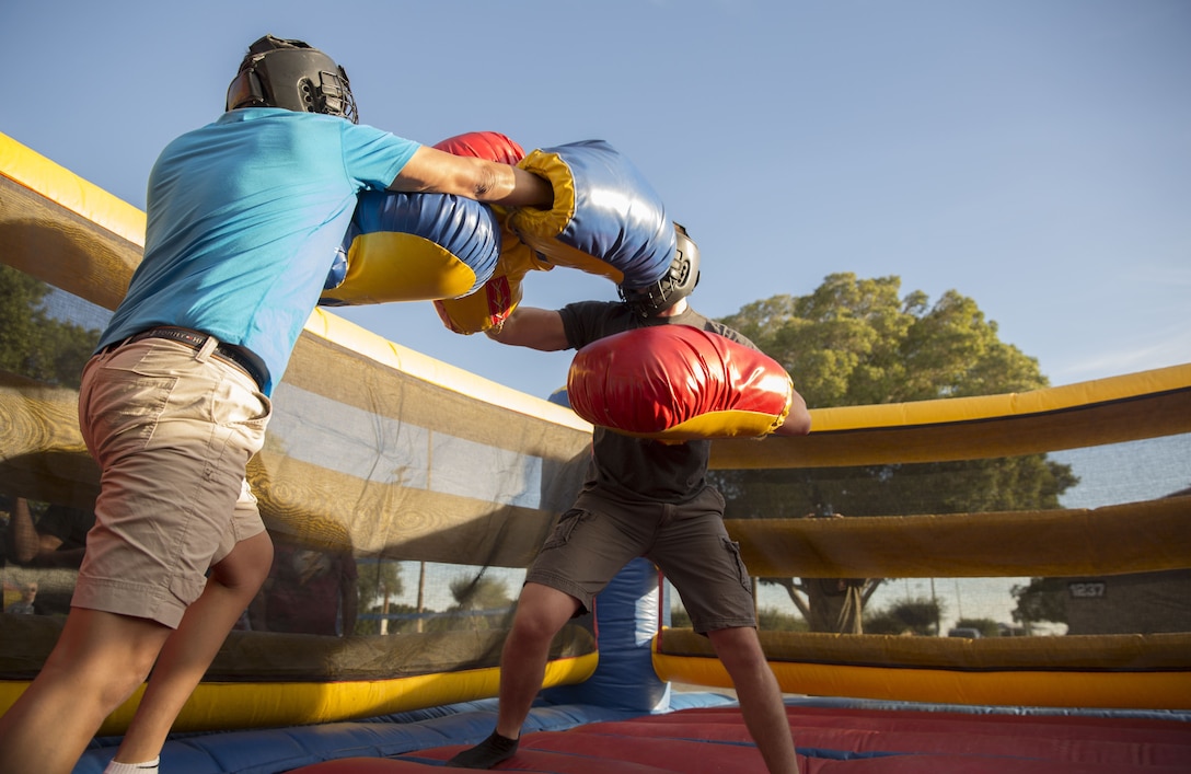 U.S. Marine Corps Data Specialist Pfc. Alexander Botello assigned to Headquarters & Headquarters Squadron (H&HS) at Marine Corps Air Station (MCAS) Yuma, Ariz., and Aircraft Rescue and Firefighting Specialist Sgt. Devin Pafford, assigned to H&HS at MCAS Yuma, box each other in the ring during the boxing event at the H&HS Barracks Bash at Ramada Field Jan. 18, 2018. H&HS leadership and the station Single Marine Program coordinated the event to boost morale through fun, friendly competition.(U.S. Marine Corps photo taken by Lance Cpl. Sabrina Candiaflores)
