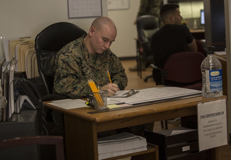 U.S. Marine Corps Lance Cpl. Daniel McKinstry, an airframe mechanic assigned to the Search and Rescue Unit with Headquarters & Headquarters Squadron, completes initial paperwork for clients that want to have their taxes prepared by the Volunteer Income Tax Assistance (VITA) Tax Center at Marine Corps Air Station (MCAS) Yuma, Ariz., Jan. 22, 2018. The VITA Tax Center offers free tax preparation to all service members, Department of Defense employees, and family members at MCAS Yuma. (U.S. Marine Corps photo taken by Lance Cpl. Sabrina Candiaflores)