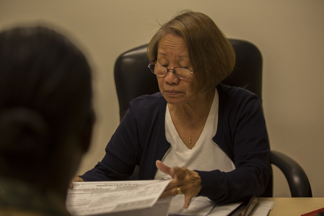 Erlinda Knight, the Volunteer Income Tax Assistance (VITA) Tax Center Coordinator, prepares taxes for a client at the VITA Tax Center at Marine Corps Air Station (MCAS) Yuma, Ariz., Jan. 22, 2018. The VITA Tax Center offers free tax preparation to all service members, Department of Defense employees, and family members at MCAS Yuma. (U.S. Marine Corps photo taken by Lance Cpl. Sabrina Candiaflores)