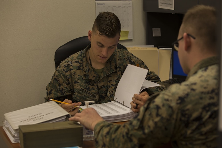 U.S. Marine Corps Cpl. Dylan Peterson, a refrigeration and air conditioning technician assigned to Marine Corps Air Control Squadron (MACS) 1, prepares taxes for a client at the Volunteer Income Tax Assistance (VITA) Tax Center at Marine Corps Air Station (MCAS) Yuma, Ariz., Jan. 22, 2018. The VITA Tax Center offers free tax preparation to all service members, Department of Defense employees, and family members at MCAS Yuma. (U.S. Marine Corps photo taken by Lance Cpl. Sabrina Candiaflores)