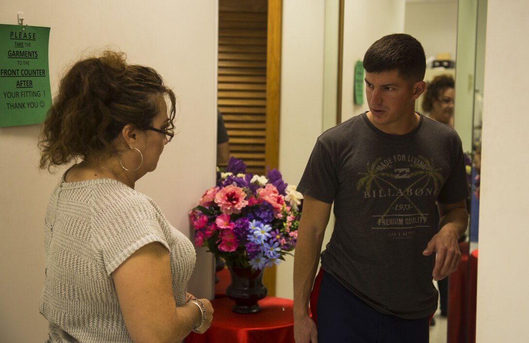 Blanca Quintero, a seamstress at the station dry-cleaners, speaks with a U.S. Marine at the dry-cleaners on Marine Corps Air Station Yuma, Ariz., Jan. 10, 2017. The station dry-cleaners is a service provided by the Marine Corps Exchange (MCX) to Marines and civilians, which provides them the opportunity to get their garments cleaned, pressed, fitted, altered or a combination of services if needed. (U.S. Marine Corps photo taken by Cpl. Isaac Martinez)