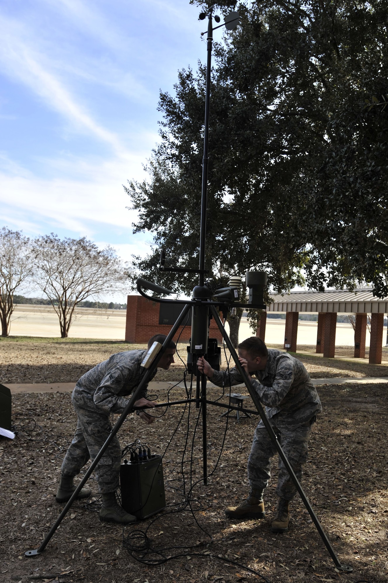 U.S. Air Force Airman 1st Class Ryan Burns, 20th Operations Support Squadron (OSS) weather flight weather journeyman, left, and Airman 1st Class Austin Carter, 20th OSS weather flight weather apprentice, set up a TMQ-53 tactical meteorological observing system at Shaw Air Force Base, S.C., Jan. 26, 2018.