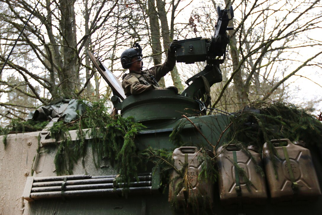 A soldier provides security from the turret of his M109A Paladin self-propelled howitzer.