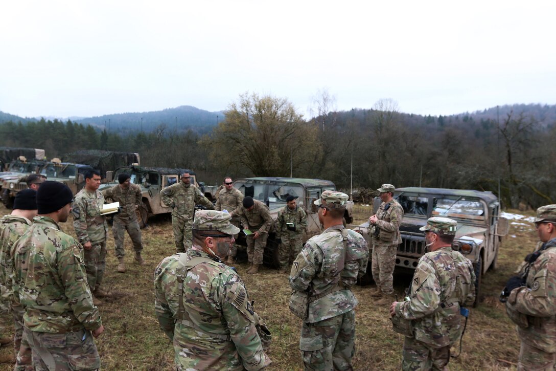 Soldiers conduct an after action review with their observer controllers.