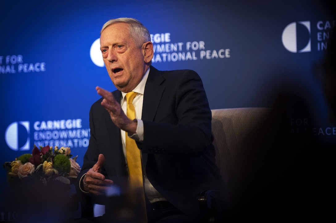 Defense Secretary James N. Mattis making a hand gesture while talking to an audience.