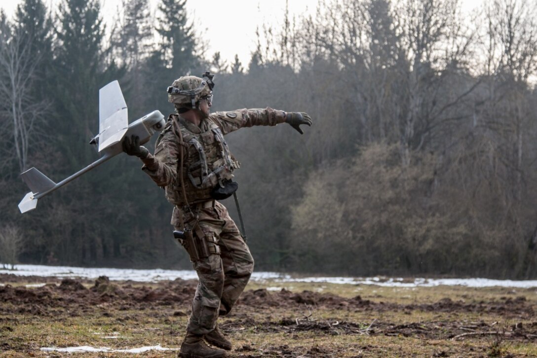 Army Spc. William Ritter, a military policeman with 287th Military Police Company, 97th Military Police Battalion, 89th Military Police Brigade, Fort Riley, Kan., prepares to launch the RQ-11 Raven, small unmanned aerial system into the air during Allied Spirit VIII at Hohenfels Training Area, Germany.
