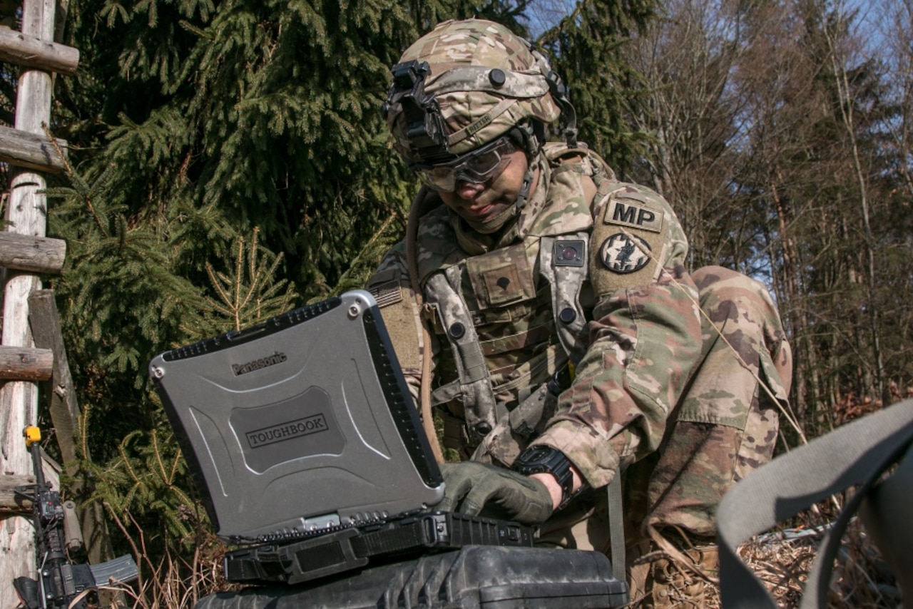 Army Spc. William Ritter, a military policeman with 287th Military Police Company, 97th Military Police Battalion, 89th Military Police Brigade, Fort Riley, Kan., sets up the software used to monitor and control the RQ-11 Raven, a small unmanned aerial system, during Allied Spirit VIII at Hohenfels Training Area, Germany.