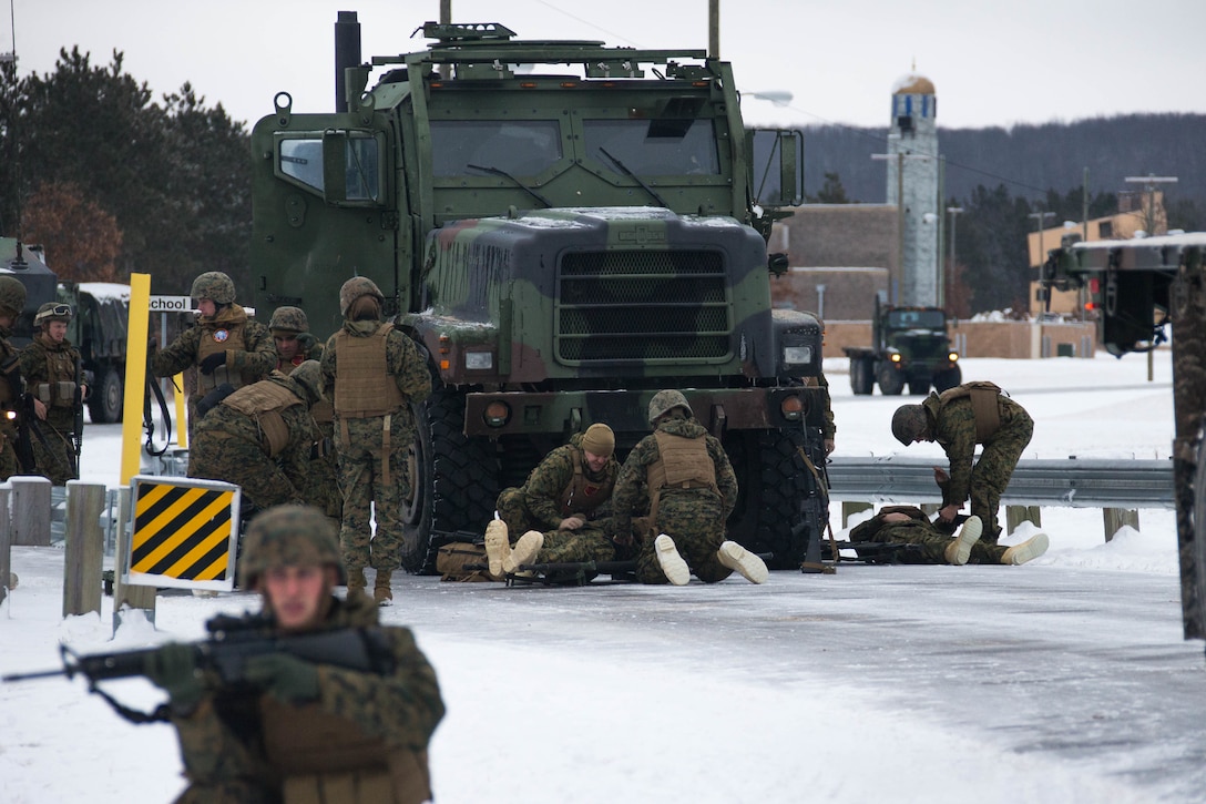 Marines attend to simulated casualties during roadside bomb training during exercise Ullr Shield on Fort McCoy, Wisconsin.