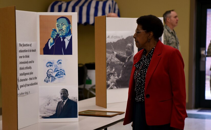 An attendee at a Martin Luther King Jr. observance event views information about King at the Air Base Chapel Jan. 29, 2018.