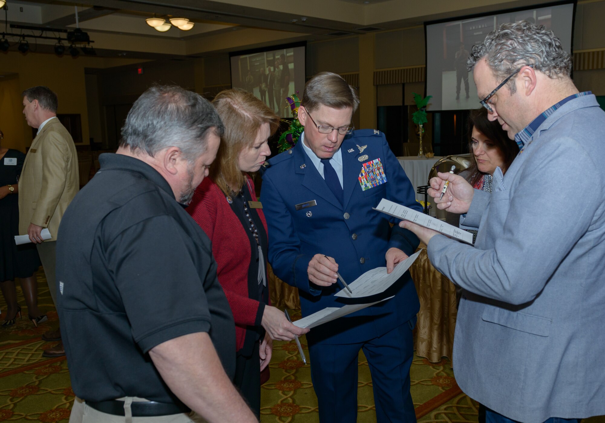 Col. Mike Smith, 81st Training Wing vice commander, assists honorary commanders in an icebreaker game during the 2018 Honorary Commanders Induction Ceremony at the Bay Breeze Event Center Jan. 26, 2018, on Keesler Air Force Base, Mississippi. The event recognized the newest members of Keesler’s honorary commanders program, which is a partnership between base leadership and local civic leaders to promote strong ties between military and civilian leaders. (U.S. Air Force photo by André Askew)